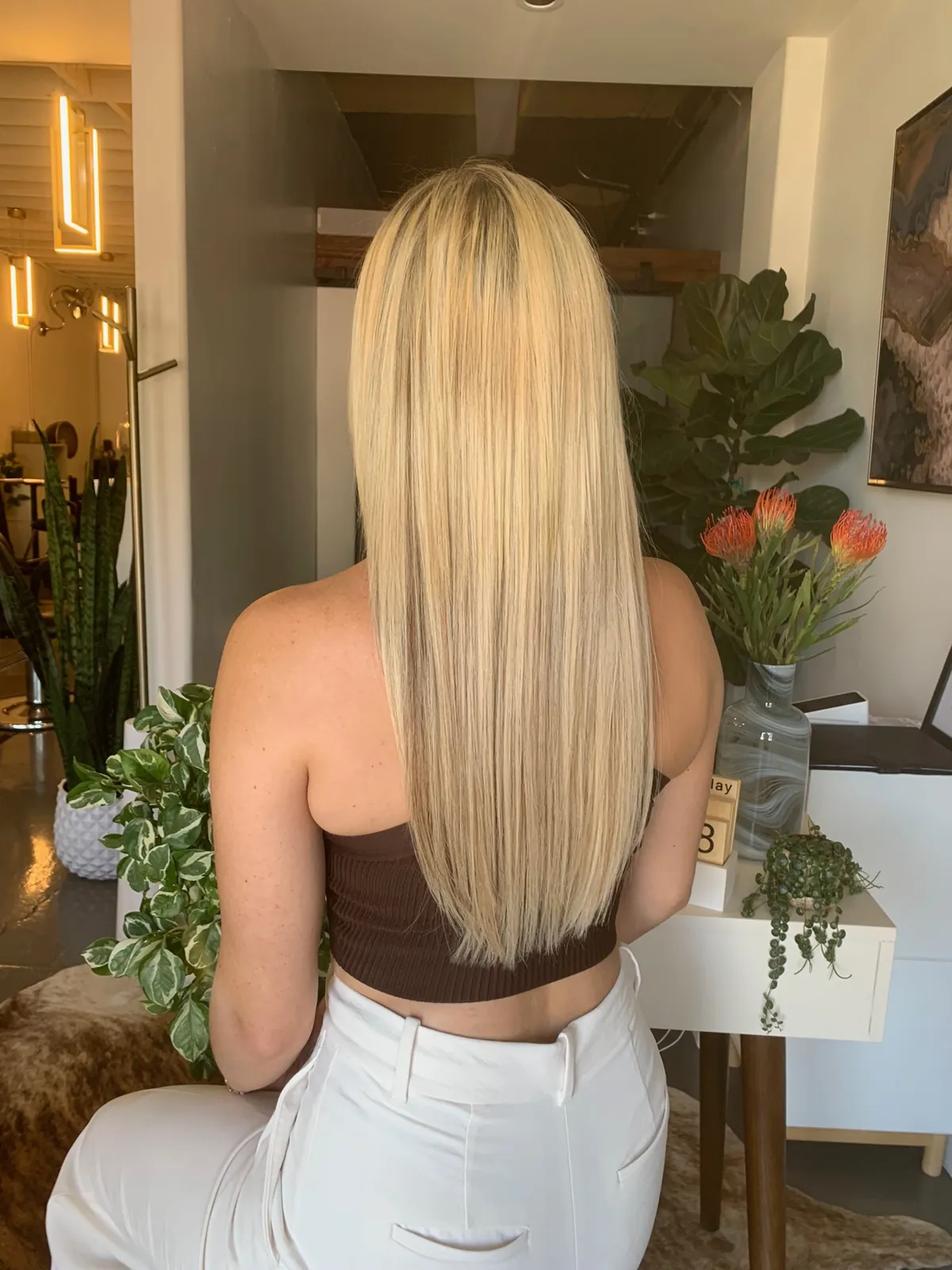 After: long straight blonde hair past the shoulder blades.