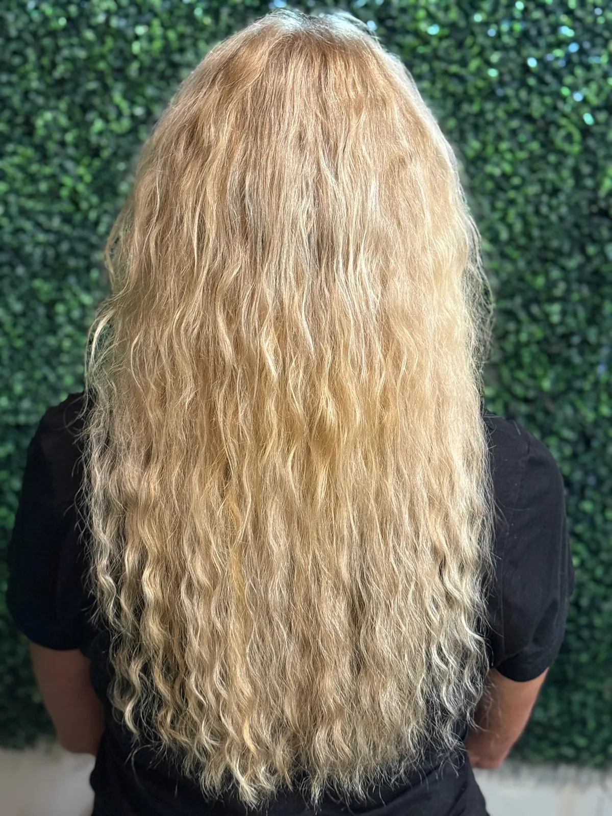 After: longer, fuller curly blonde hair.