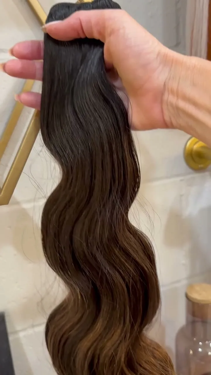 A thick volume weft held in the hand, the length falling in a wave.
